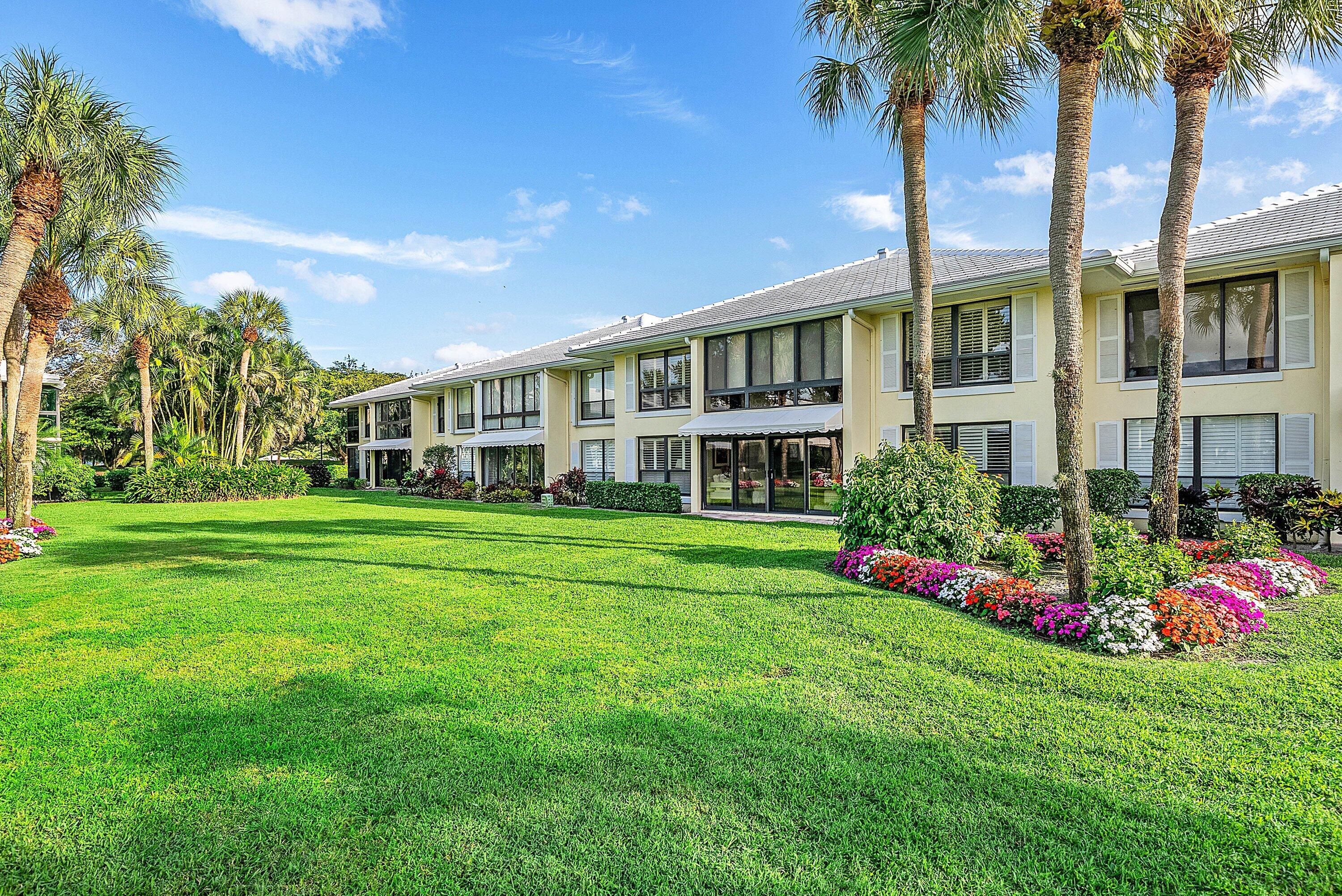 3675 Quail Ridge Drive, Unit BOBWHITE B Boynton Beach, FL 33436 - Photo 29 of 48 a front view of a house with plants and garden