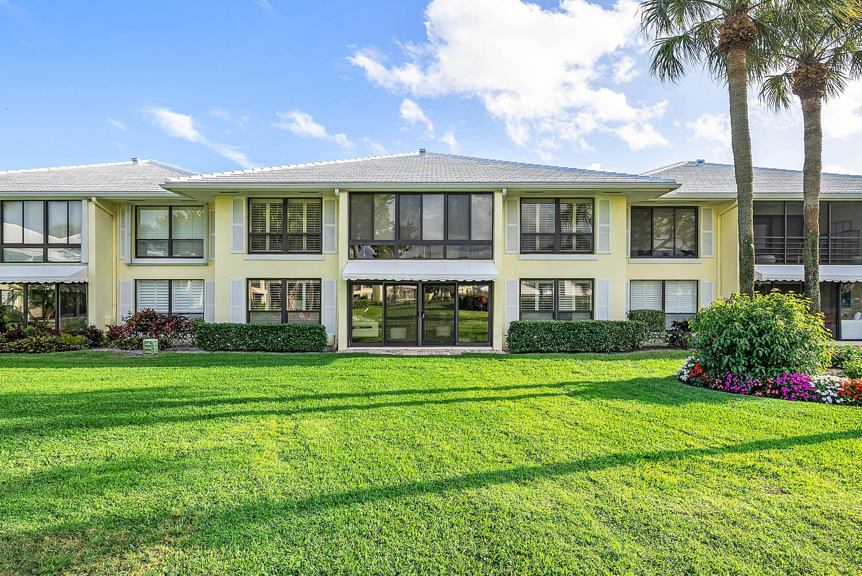 3675 Quail Ridge Drive, Unit BOBWHITE B Boynton Beach, FL 33436 - Photo 30 of 48 a front view of a residential apartment building with a yard