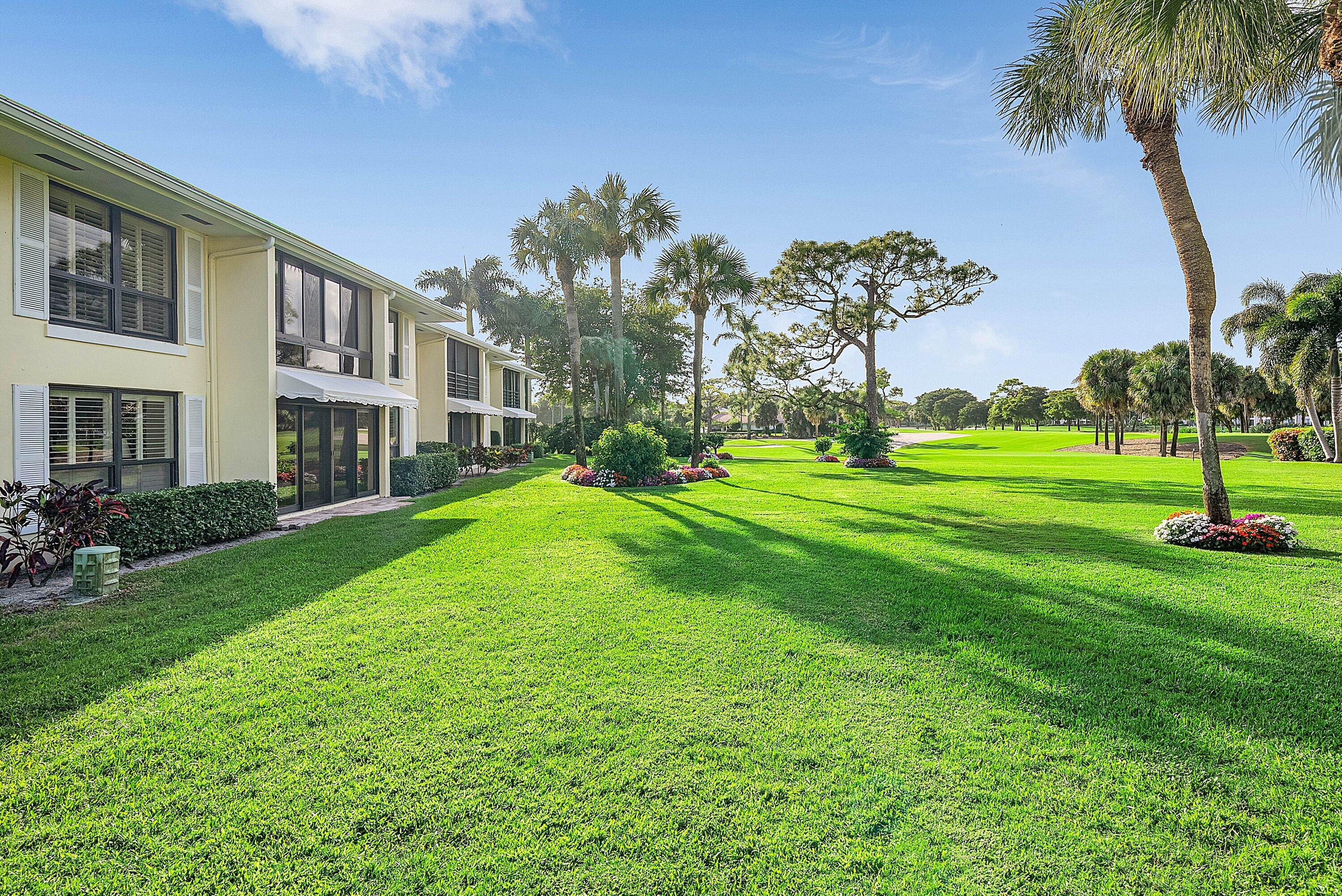 3675 Quail Ridge Drive, Unit BOBWHITE B Boynton Beach, FL 33436 - Photo 31 of 48 a big yard with palm trees