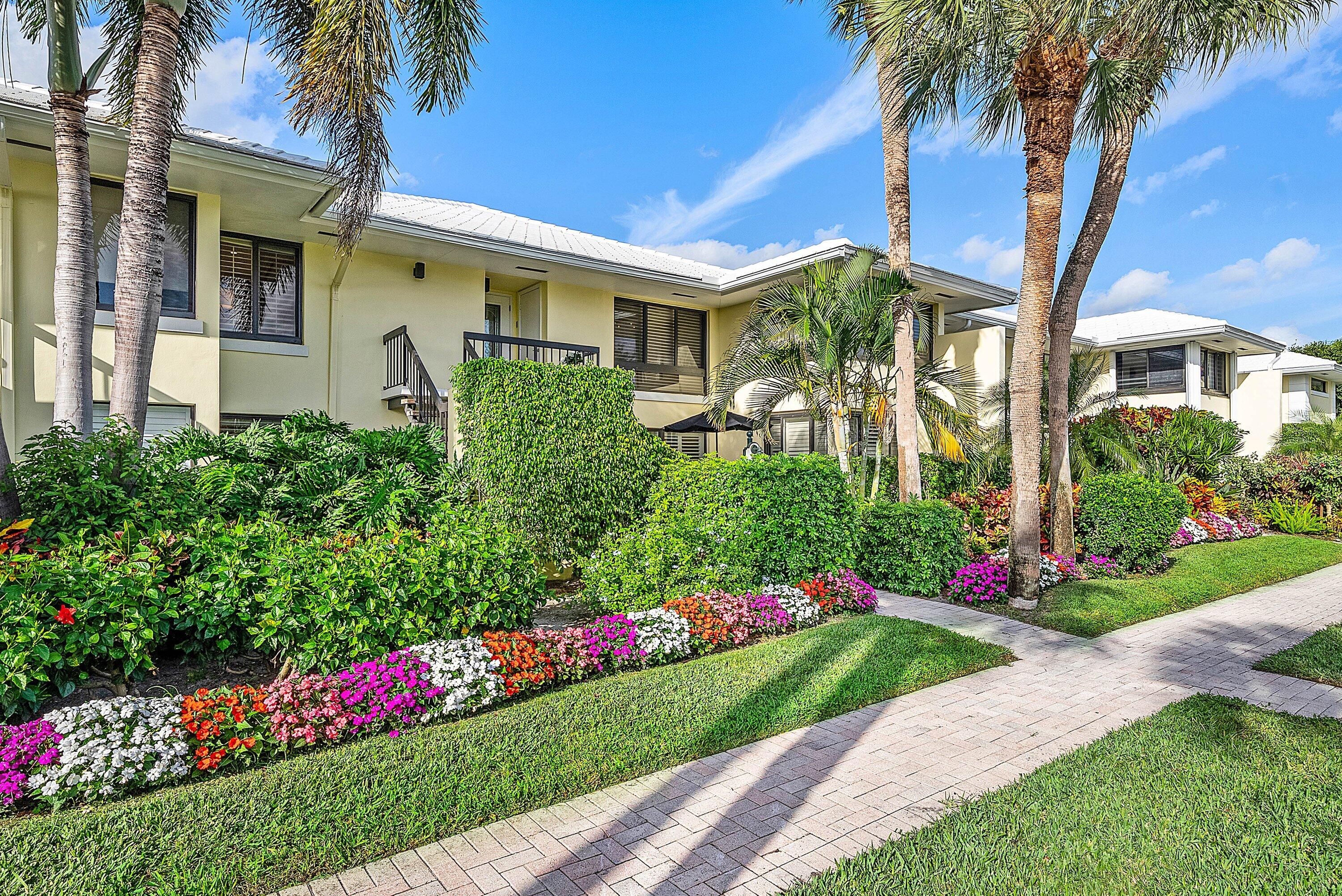 3675 Quail Ridge Drive, Unit BOBWHITE B Boynton Beach, FL 33436 - Photo 37 of 48 a front view of a house with a yard and potted plants