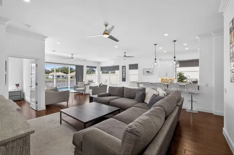 a living room with furniture and kitchen view