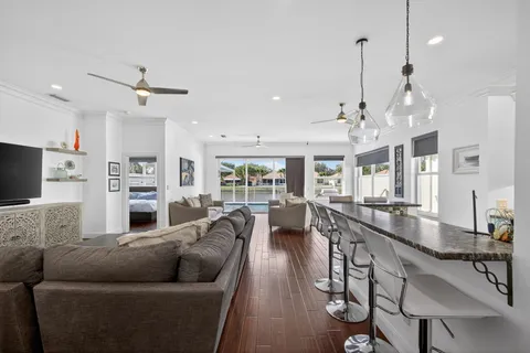 a kitchen with stainless steel appliances granite countertop a kitchen island a stove and a sink