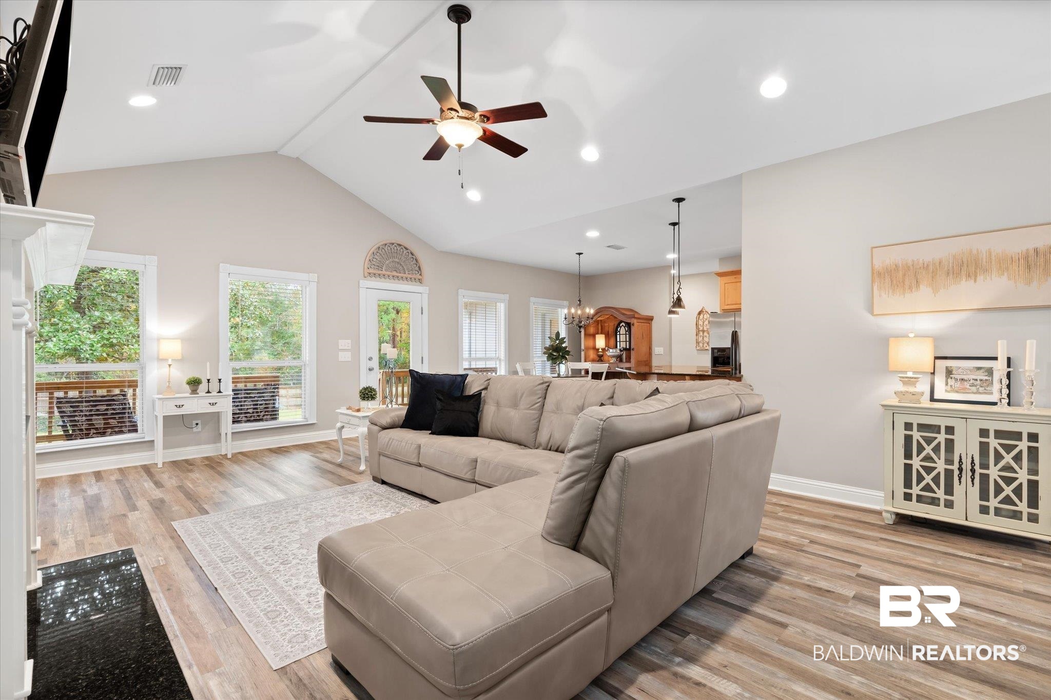 27994 Oakachoy Loop Daphne, AL 36526 - Photo 12 of 41 Living room with ceiling fan with notable chandelier, high vaulted ceiling, and light hardwood / wood-style flooring