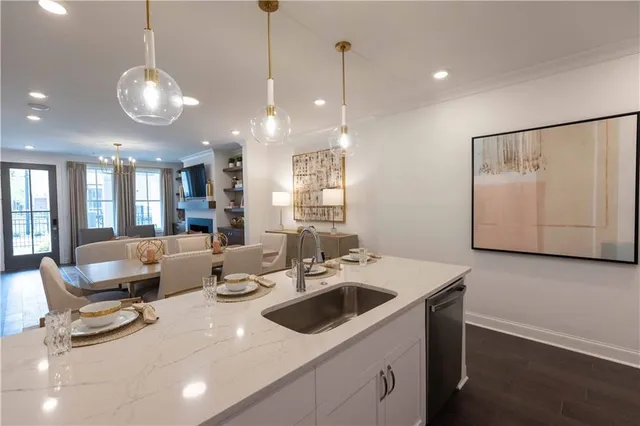 a kitchen with a sink a stove and chairs