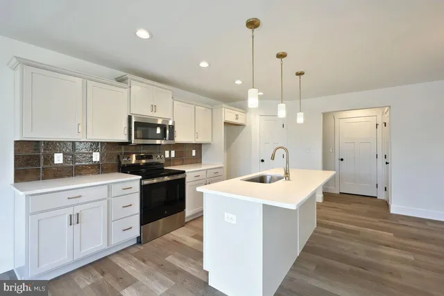 a view of kitchen with wooden floor and window