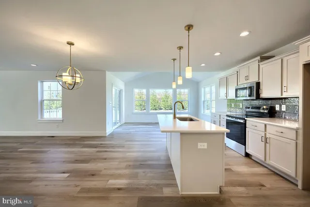 a view of empty room with wooden floor and fireplace