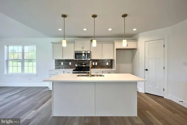 wooden floor fireplace and windows in an empty room