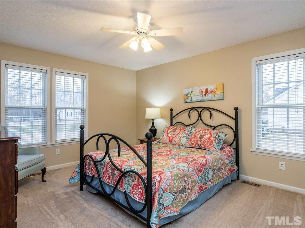 7273 Turner Fish Road Willow Spring, NC 27592 - Photo 16 of 25 A first floor master suite is a great feature. This bedroom has a walk-in-closet.