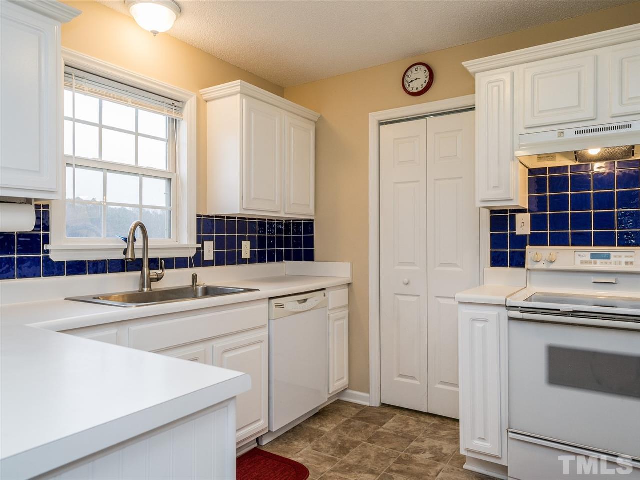 7273 Turner Fish Road Willow Spring, NC 27592 - Photo 10 of 25 This efficient kitchen has a beautiful back splash that adds a lot of interest to this well-designed space.