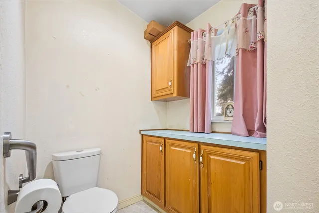 a bathroom with a toilet sink and mirror