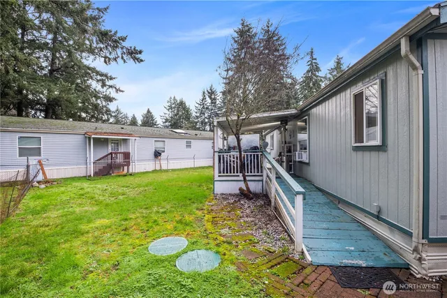 a view of a house with backyard and porch