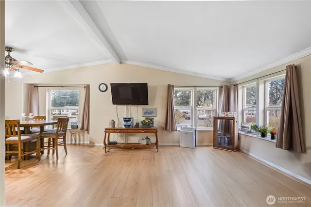 a living room with furniture wooden floor and a flat screen tv