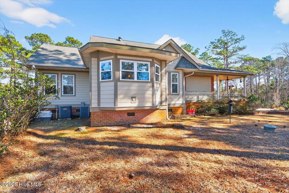 18 Brierwood Road Southwest Shallotte, NC 28470 - Photo 46 of 70 Full rear view of the home showcasing spacious outdoor living and private backyard setting.