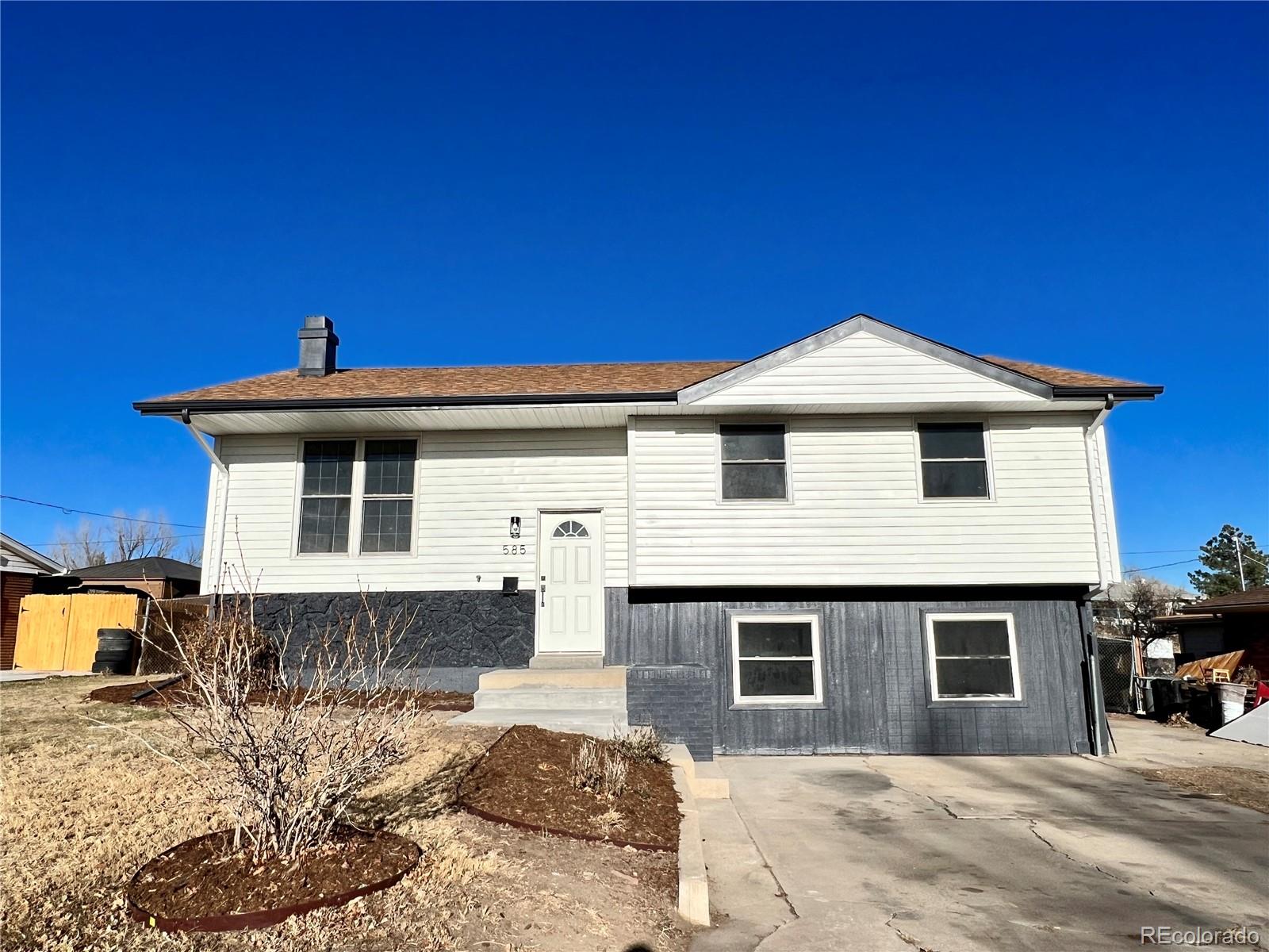 585 Sundown Lane Denver, CO 80221 - Photo 1 of 29 a front view of a house with a yard