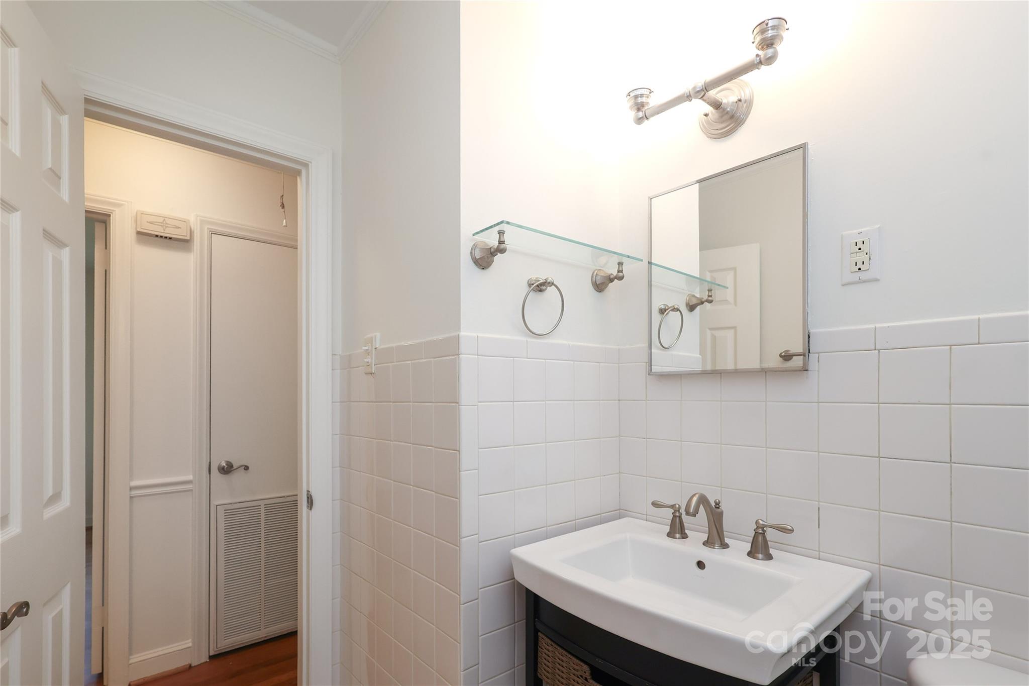 4361 Applegate Road Charlotte, NC 28209 - Photo 12 of 17 a bathroom with a sink and a mirror