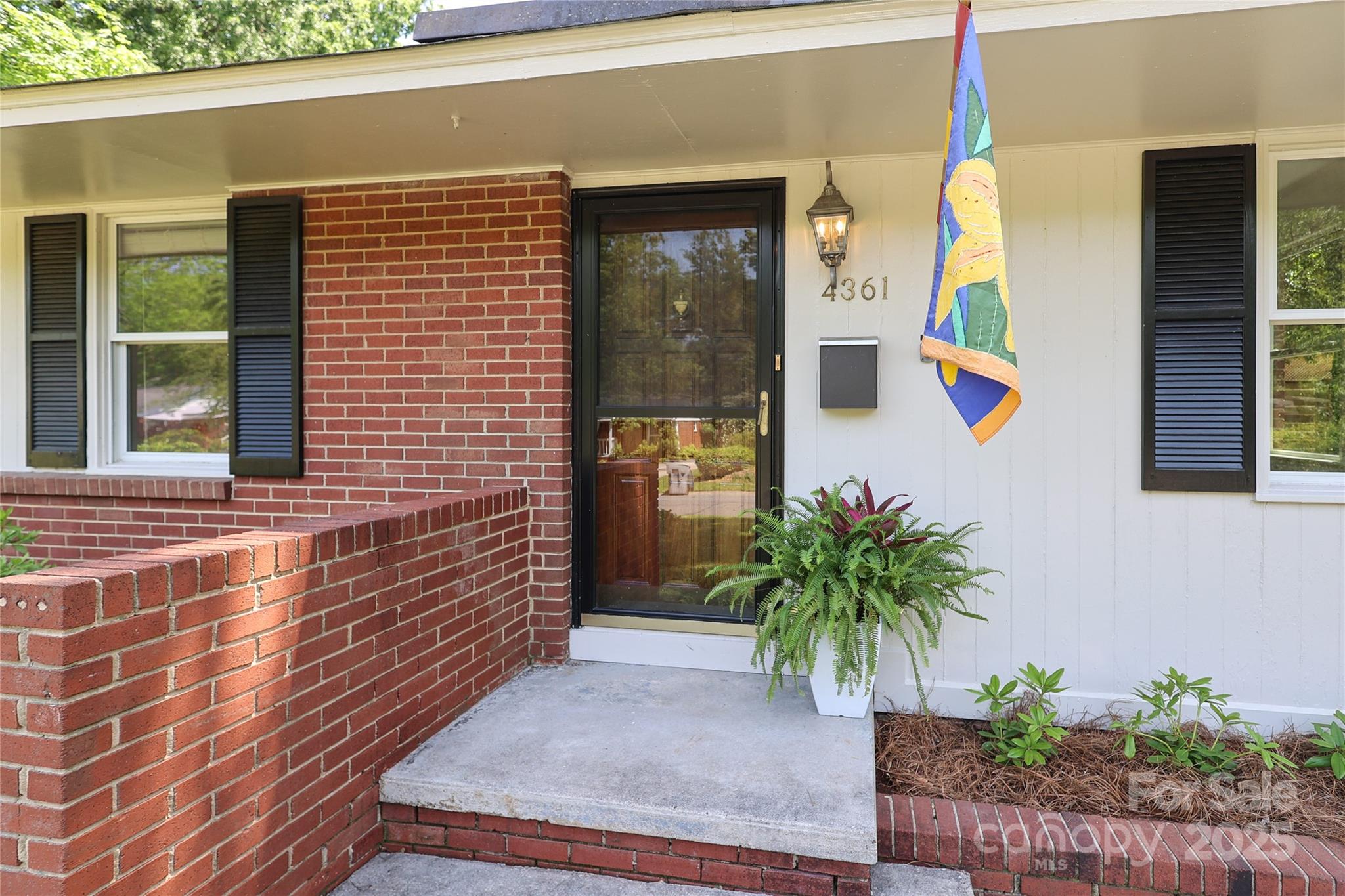 4361 Applegate Road Charlotte, NC 28209 - Photo 2 of 17 a potted plant sitting in front of a door