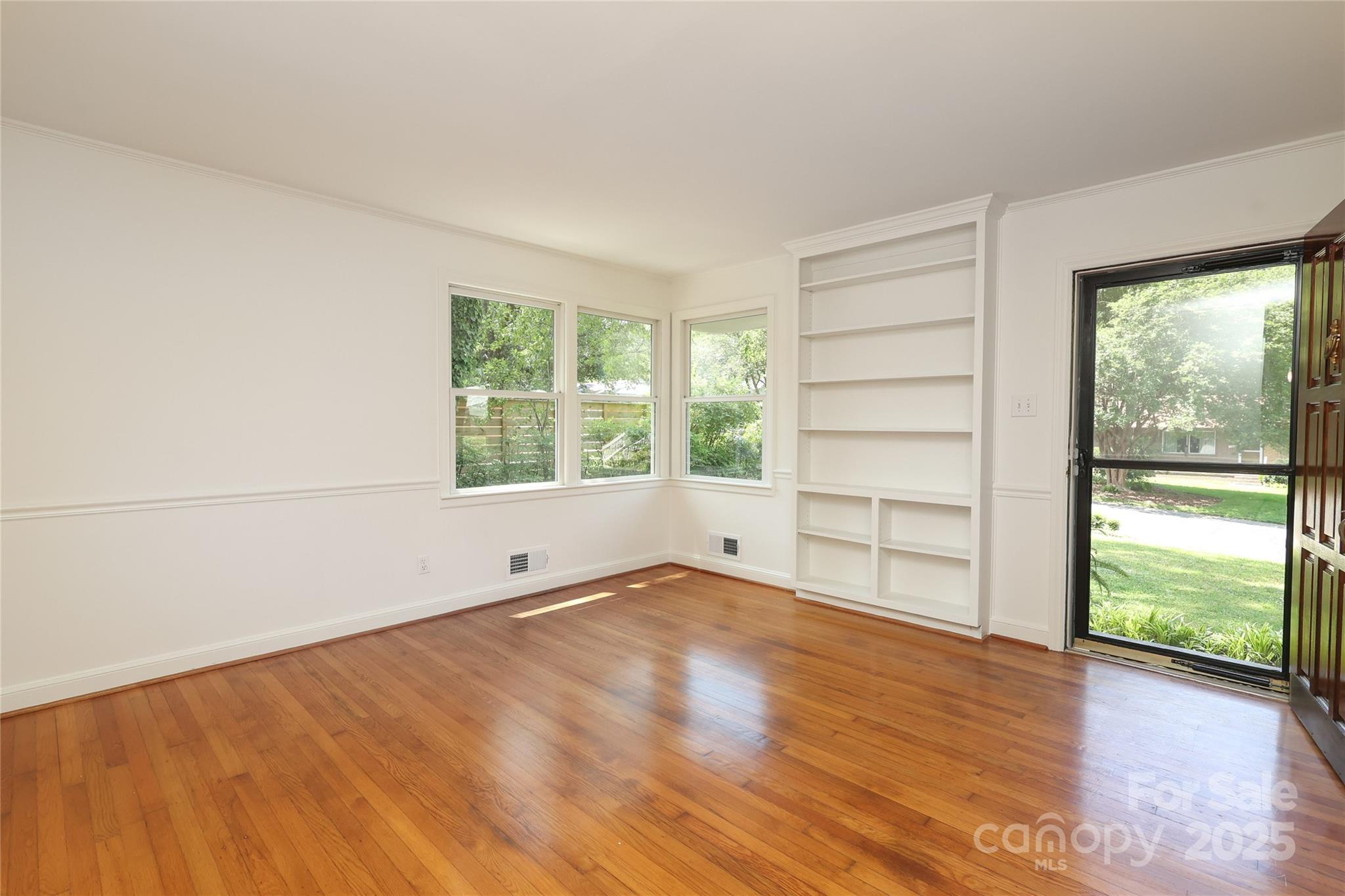 4361 Applegate Road Charlotte, NC 28209 - Photo 3 of 17 an empty room with wooden floor and windows