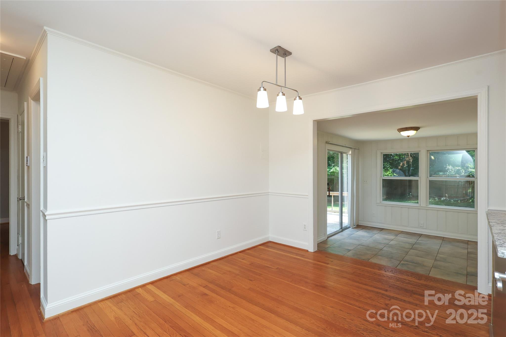 4361 Applegate Road Charlotte, NC 28209 - Photo 4 of 17 a view of empty room with wooden floor and fan
