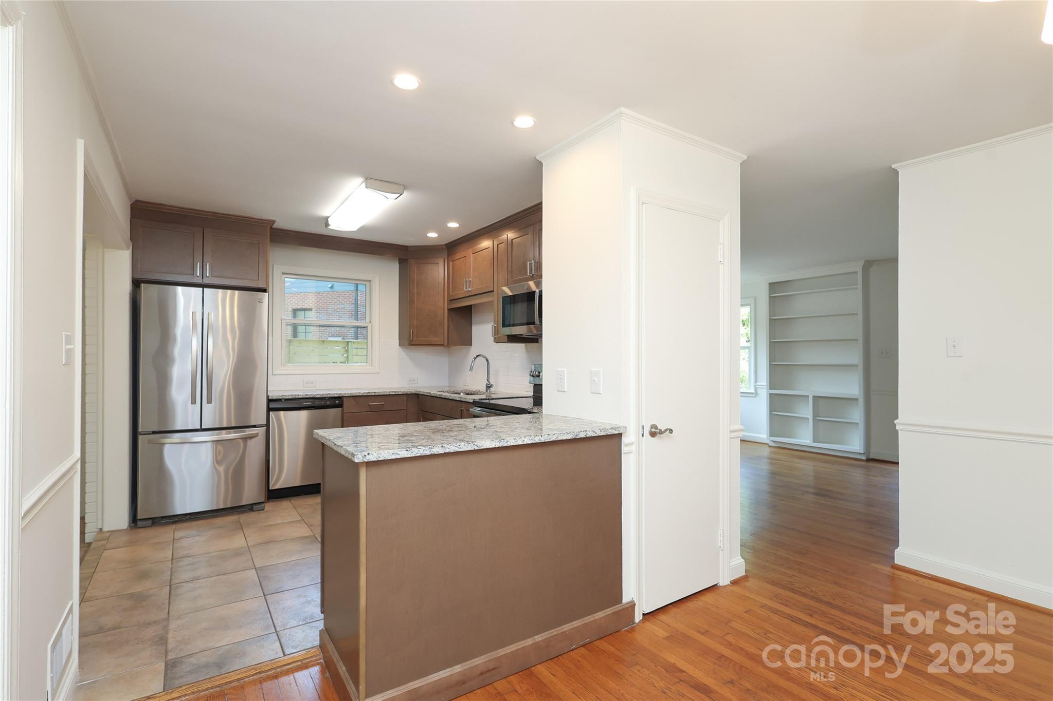 4361 Applegate Road Charlotte, NC 28209 - Photo 5 of 17 a kitchen with stainless steel appliances granite countertop a refrigerator a sink and a stove