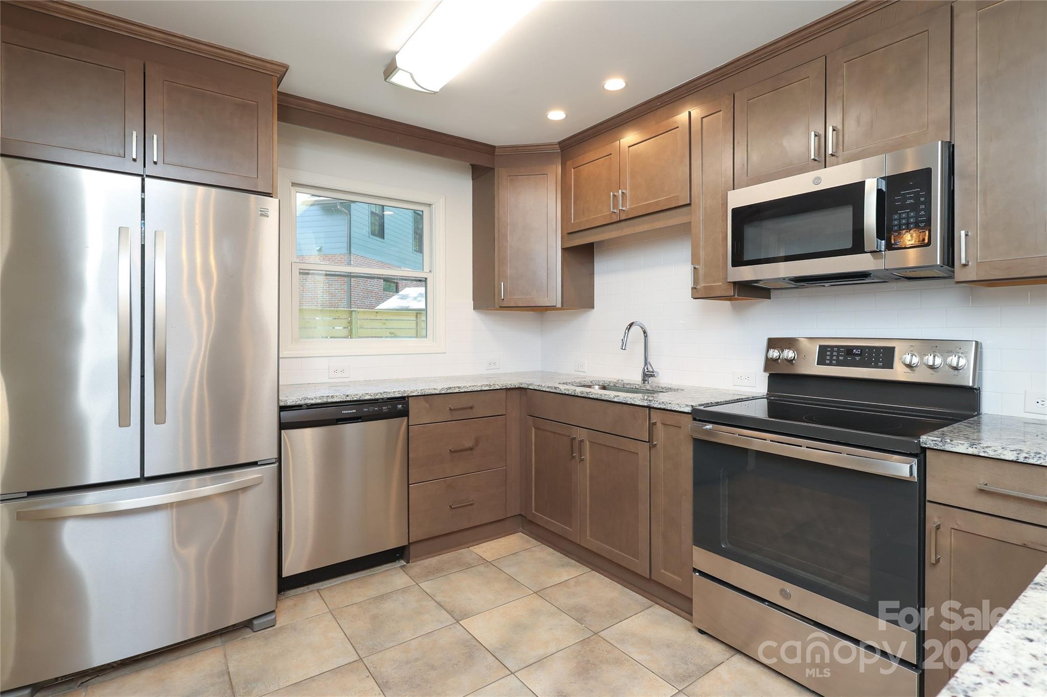 4361 Applegate Road Charlotte, NC 28209 - Photo 6 of 17 a kitchen with stainless steel appliances granite countertop a refrigerator and a stove top oven