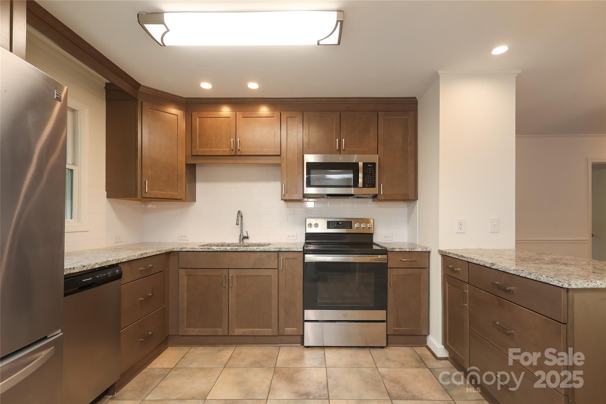 4361 Applegate Road Charlotte, NC 28209 - Photo 7 of 17 a kitchen with stainless steel appliances granite countertop a sink and stove top oven