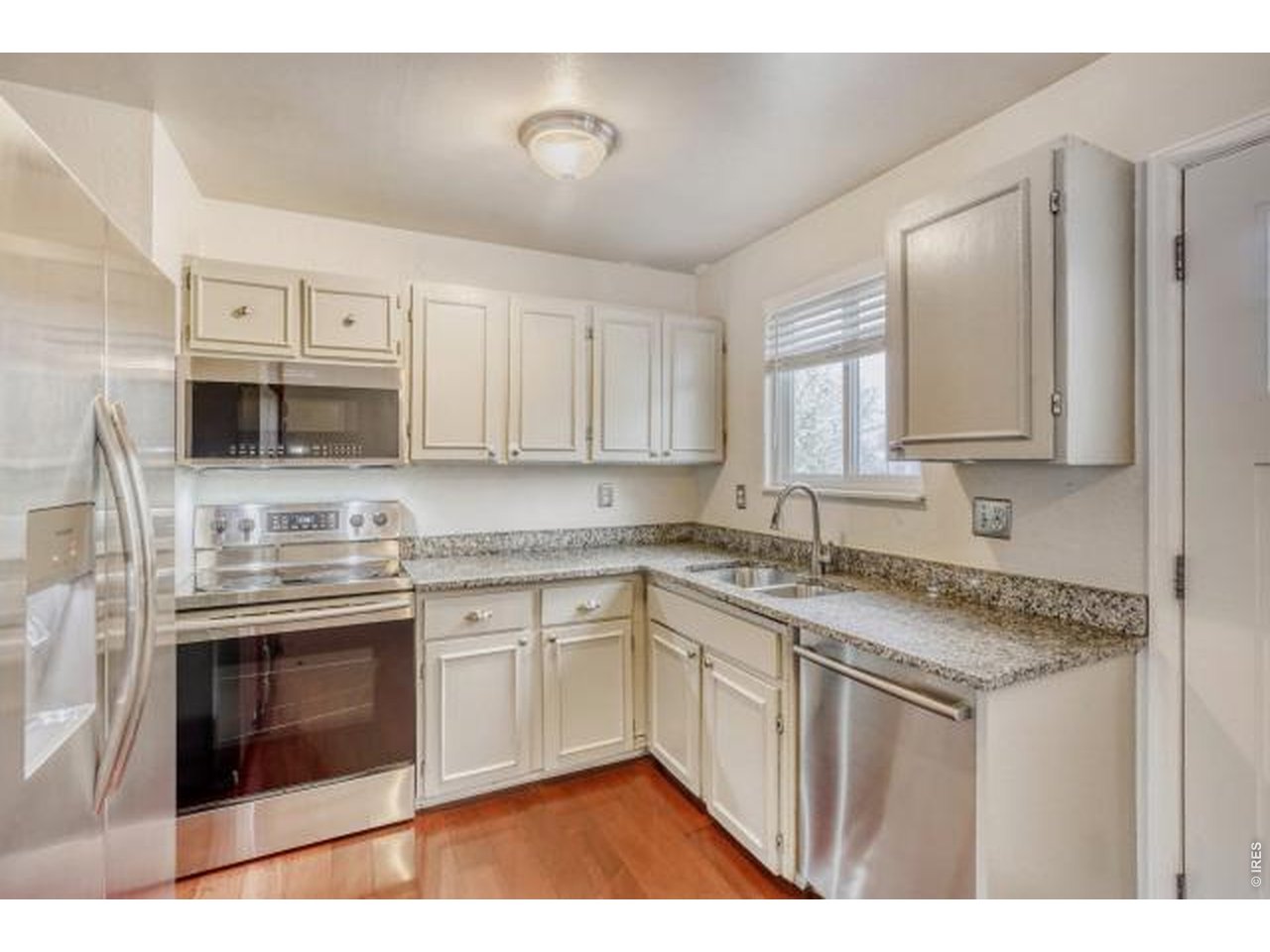 10748 Routt Street Broomfield, CO 80021 - Photo 2 of 30 a kitchen with stainless steel appliances granite countertop a stove sink and cabinets
