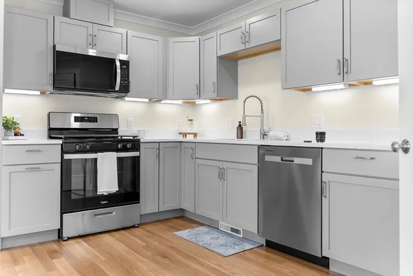 a kitchen with cabinets stainless steel appliances and a sink