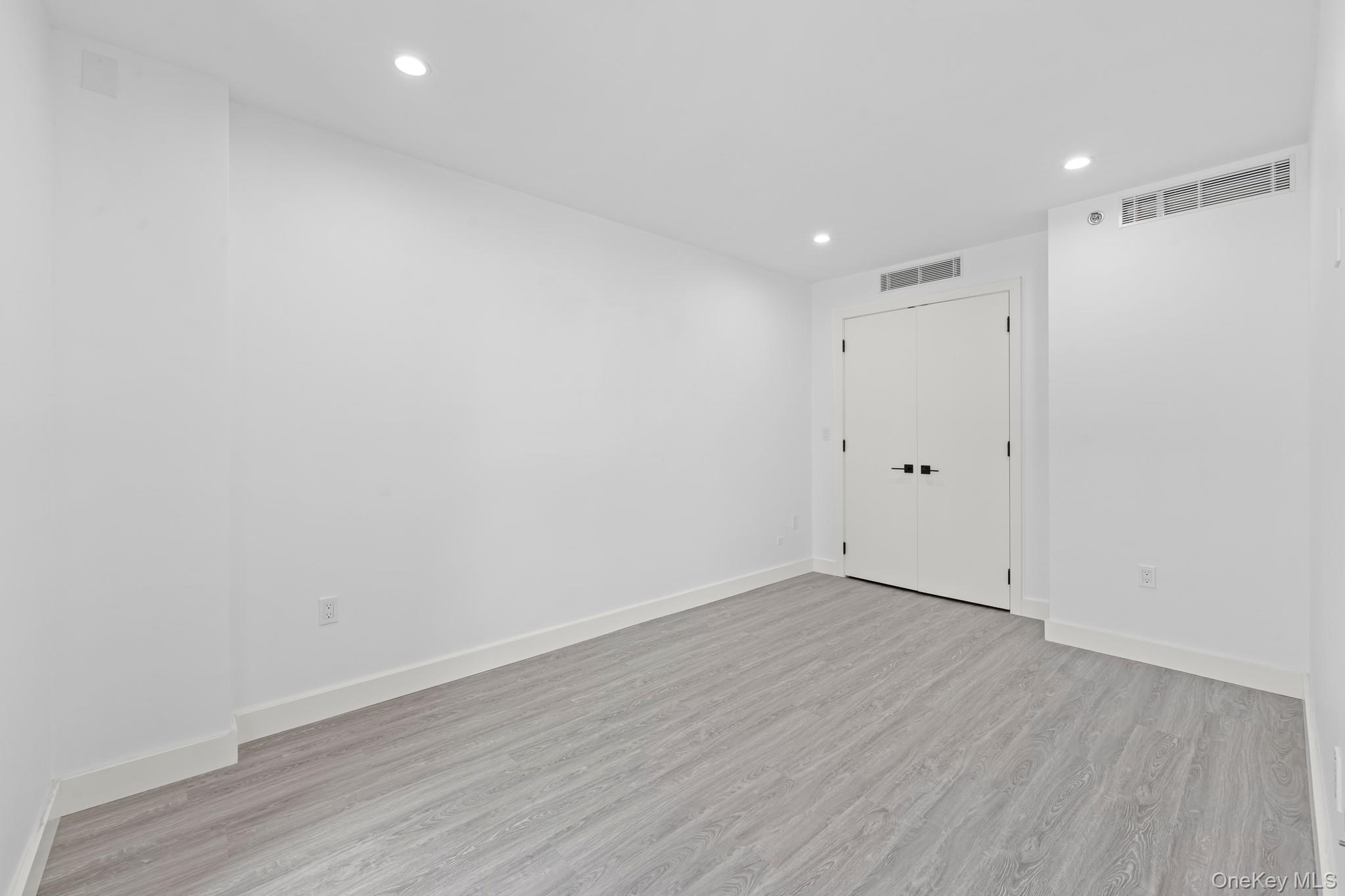 46-40 Vernon Boulevard, Unit 3B Queens, NY 11101 - Photo 11 of 17 Unfurnished room with recessed lighting and light wood-type flooring