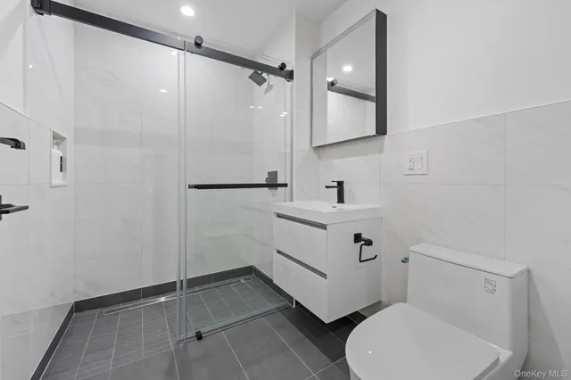 a bathroom with a toilet sink and shower