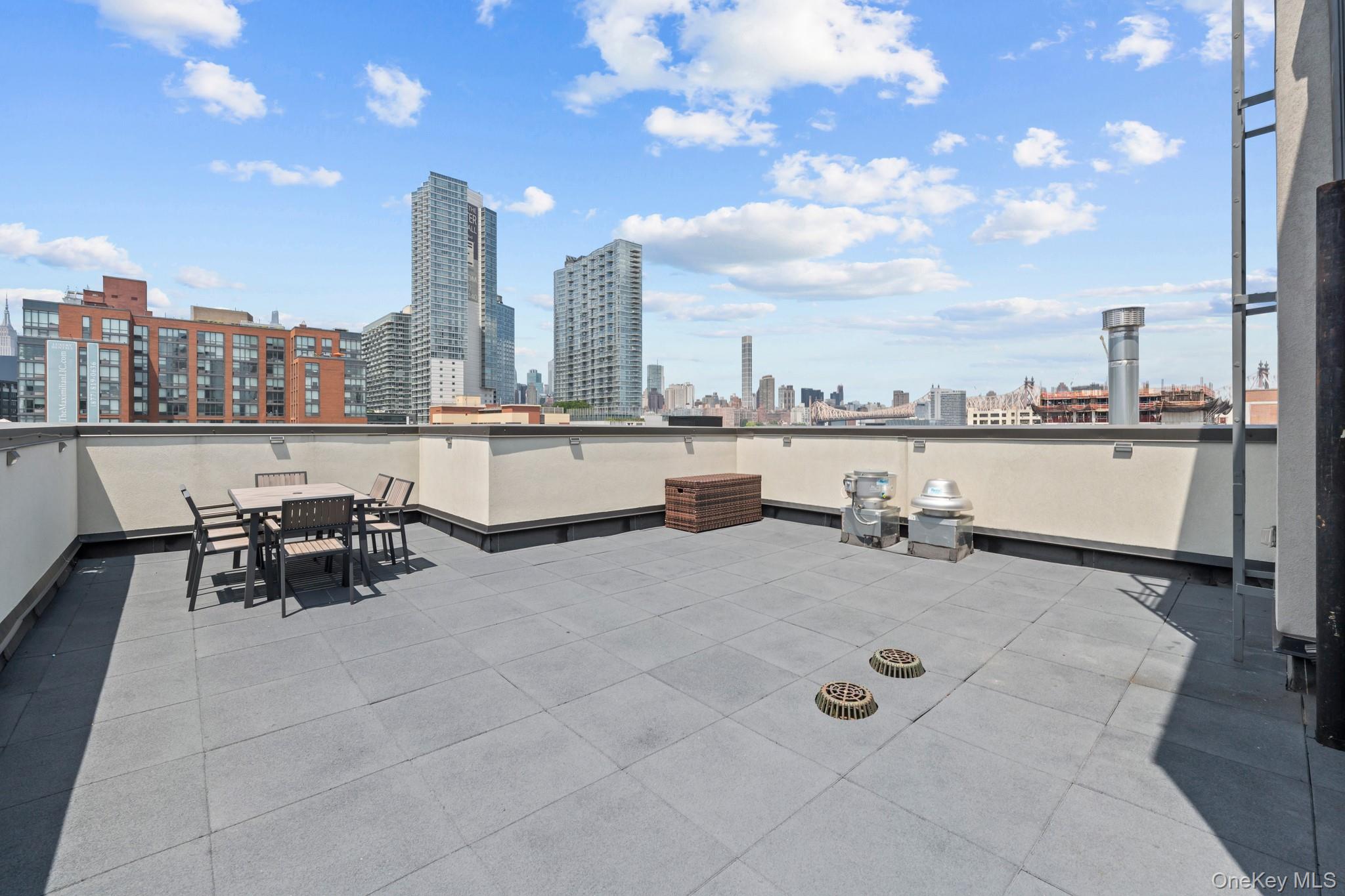 46-40 Vernon Boulevard, Unit 3B Queens, NY 11101 - Photo 14 of 17 View of patio featuring a skyline view and outdoor dining space