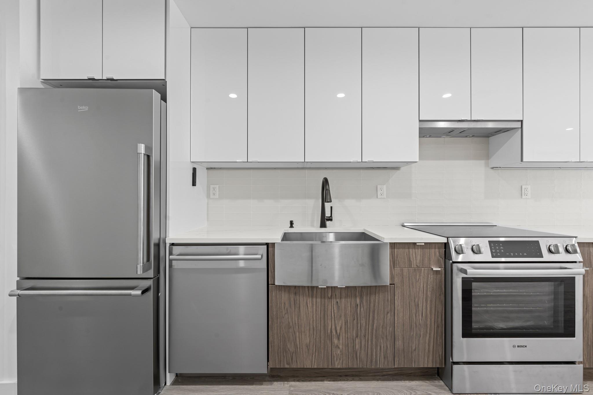 46-40 Vernon Boulevard, Unit 3B Queens, NY 11101 - Photo 6 of 17 Kitchen featuring stainless steel appliances, modern cabinets, white cabinets, and decorative backsplash