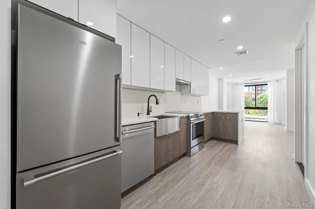 a kitchen with stainless steel appliances a refrigerator sink and cabinets