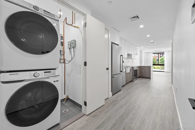 a view of a hallway with washer and dryer