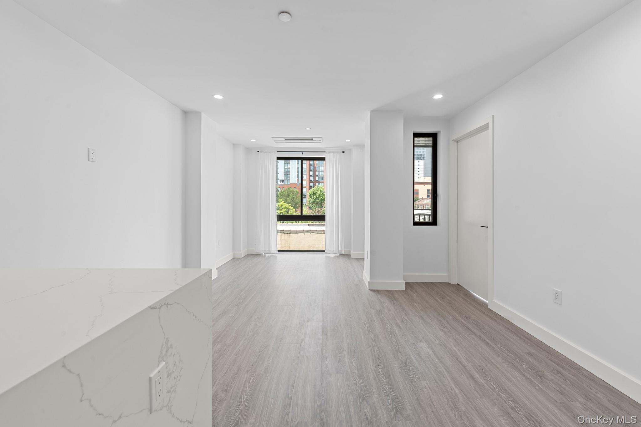 46-40 Vernon Boulevard, Unit 3B Queens, NY 11101 - Photo 9 of 17 Empty room with light wood-style flooring and recessed lighting