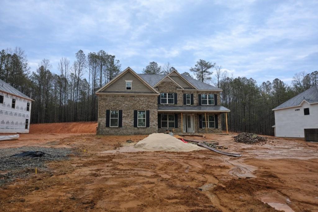 3268 Lions Ruby Lane Atlanta, GA 30349 - Photo 1 of 18 a front view of a house with a yard and trees