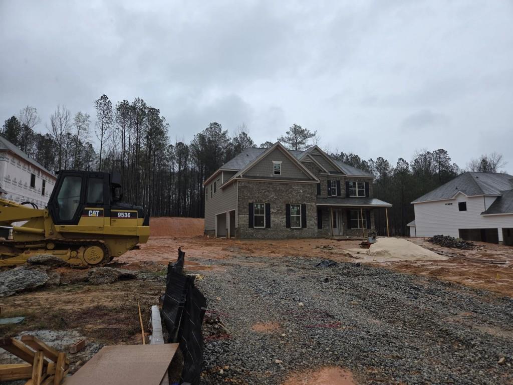 3268 Lions Ruby Lane Atlanta, GA 30349 - Photo 2 of 18 a view of a house with a yard covered with snow in the background