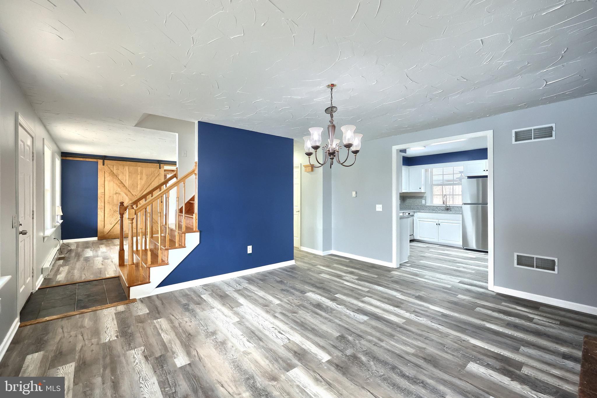 5077 Snyder Mill Road Spring Grove, PA 17362 - Photo 15 of 71 a view of a livingroom with a chandelier fan and windows