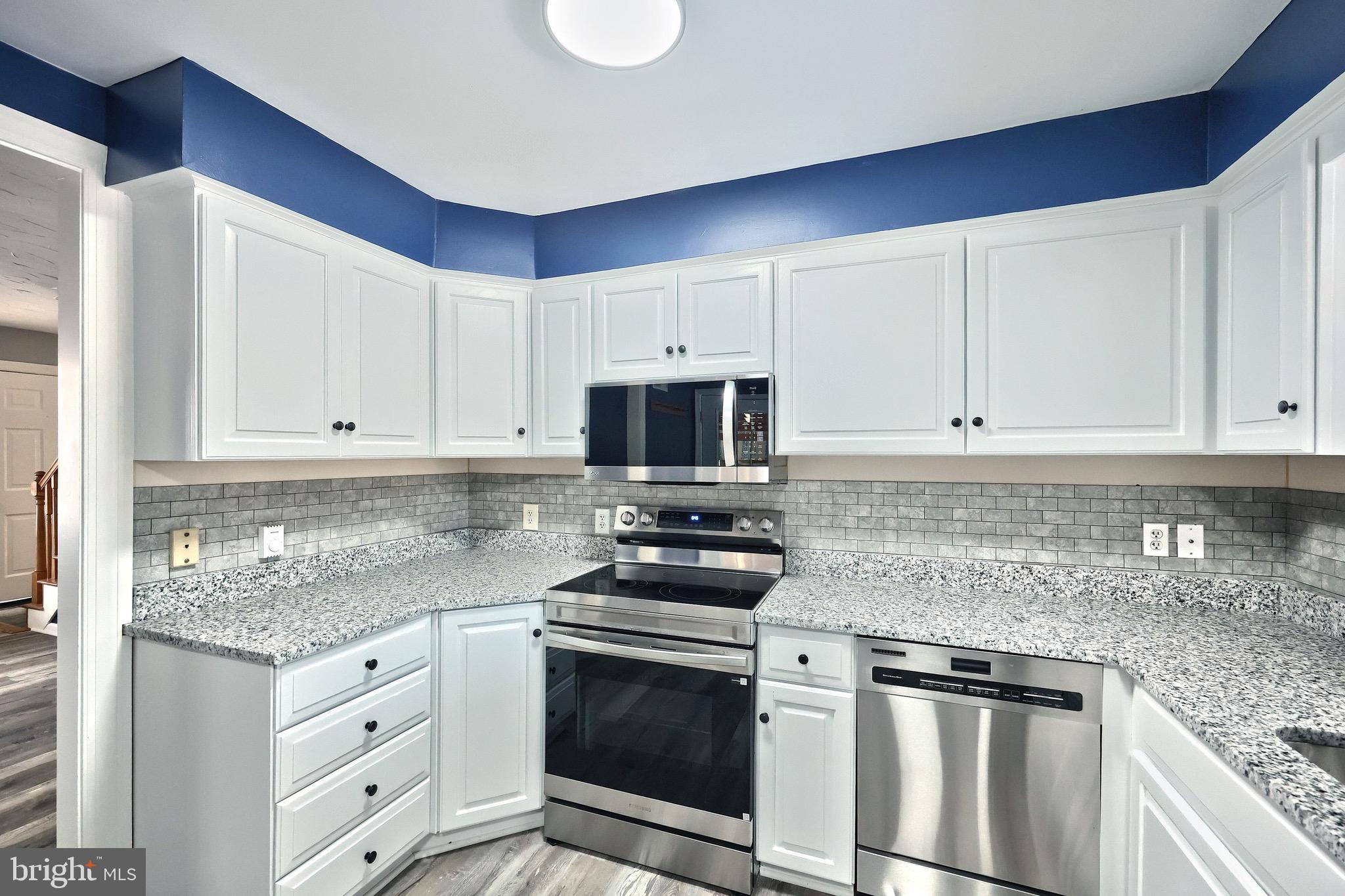 5077 Snyder Mill Road Spring Grove, PA 17362 - Photo 16 of 71 a kitchen with granite countertop white cabinets and stainless steel appliances