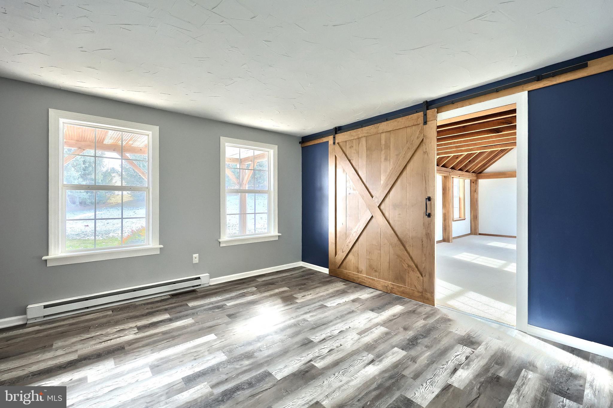 5077 Snyder Mill Road Spring Grove, PA 17362 - Photo 20 of 71 a view of an empty room with wooden floor and a window