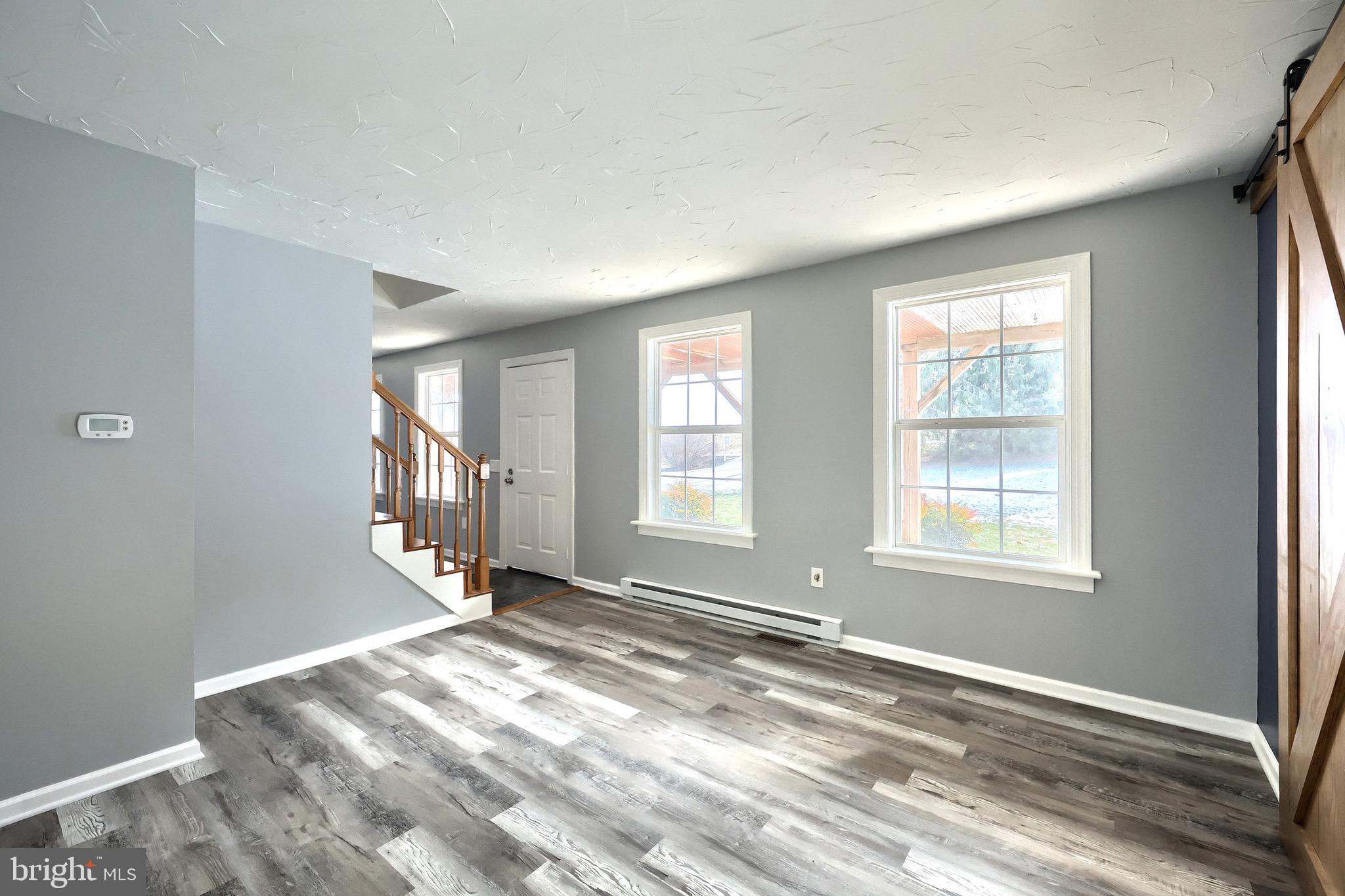 5077 Snyder Mill Road Spring Grove, PA 17362 - Photo 21 of 71 a view of an empty room with wooden floor and a window