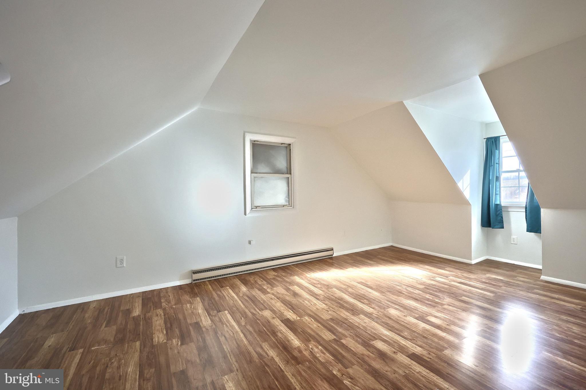 5077 Snyder Mill Road Spring Grove, PA 17362 - Photo 32 of 71 a view of an empty room with wooden floor and a window