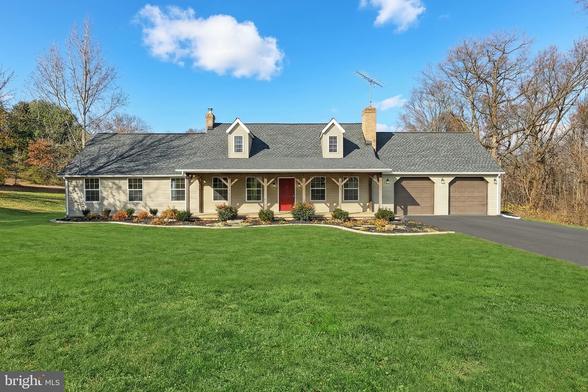 5077 Snyder Mill Road Spring Grove, PA 17362 - Photo 5 of 71 a front view of a house with a yard table and chairs