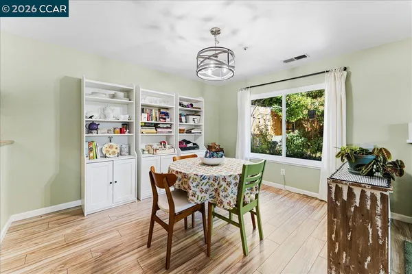 a dining room with furniture and window