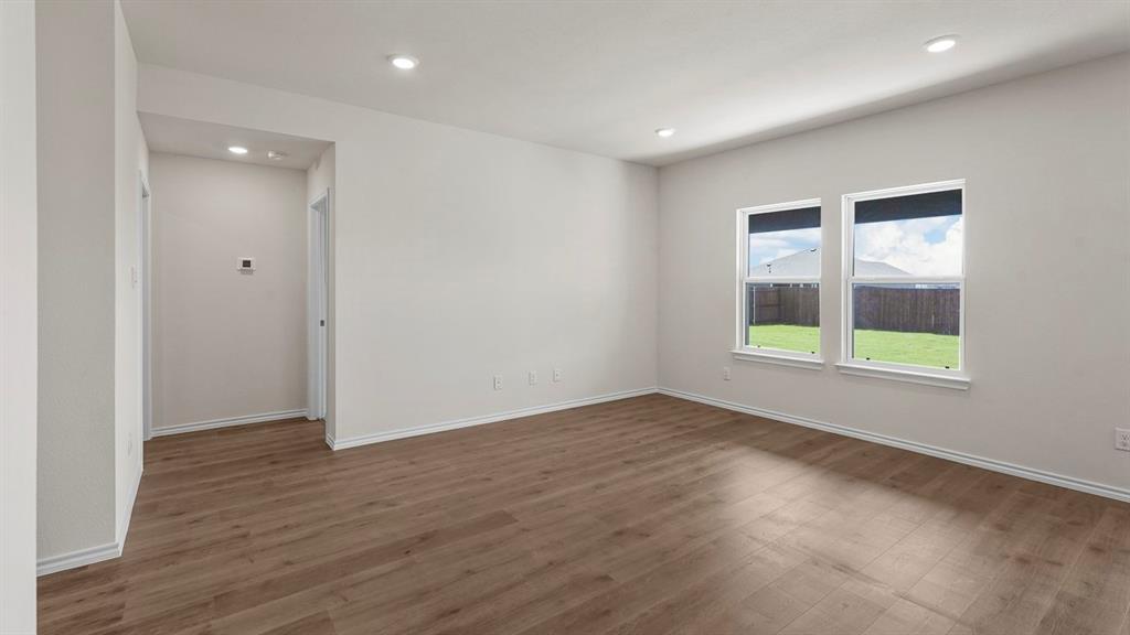 1675 Mantle Road Crandall, TX 75114 - Photo 12 of 27 Spacious room featuring wood-finish flooring, recessed lighting, and two windows with roller shades
