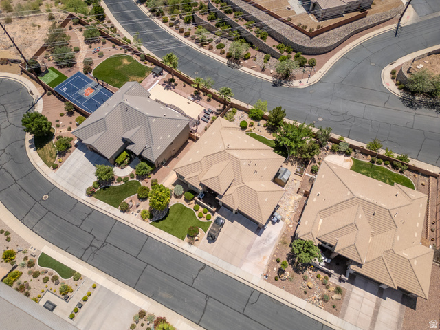 2005 West 450 S Circle St. George, UT 84770 - Photo 52 of 57 Aerial perspective of a residential property featuring a full sport court with basketball hoop, a swimming pool, and a large patio area
