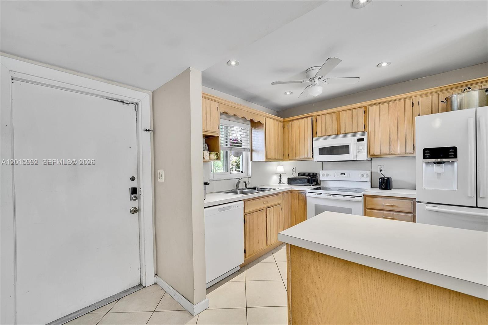 3300 Atlanta Street, Unit 15F Hollywood, FL 33021 - Photo 11 of 30 a kitchen with stainless steel appliances a refrigerator stove microwave and sink