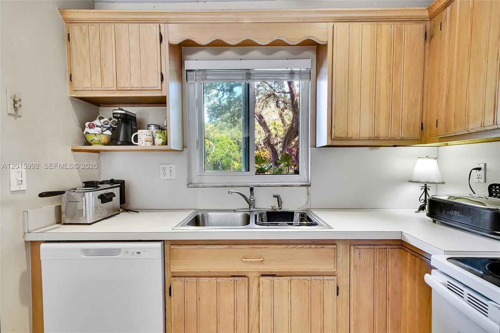 3300 Atlanta Street, Unit 15F Hollywood, FL 33021 - Photo 12 of 30 a kitchen with a window a sink and a counter