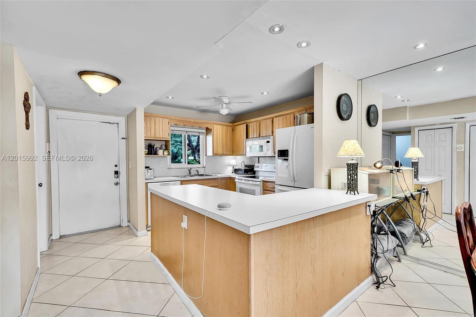 3300 Atlanta Street, Unit 15F Hollywood, FL 33021 - Photo 14 of 30 a kitchen with a sink a counter top space and stainless steel appliances