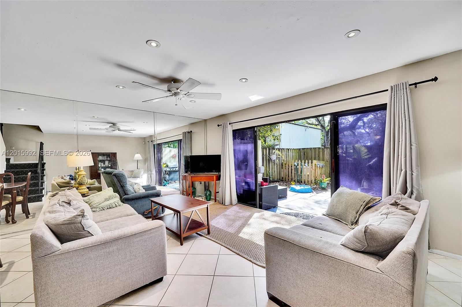 3300 Atlanta Street, Unit 15F Hollywood, FL 33021 - Photo 15 of 30 a living room with furniture ceiling fan and a large window