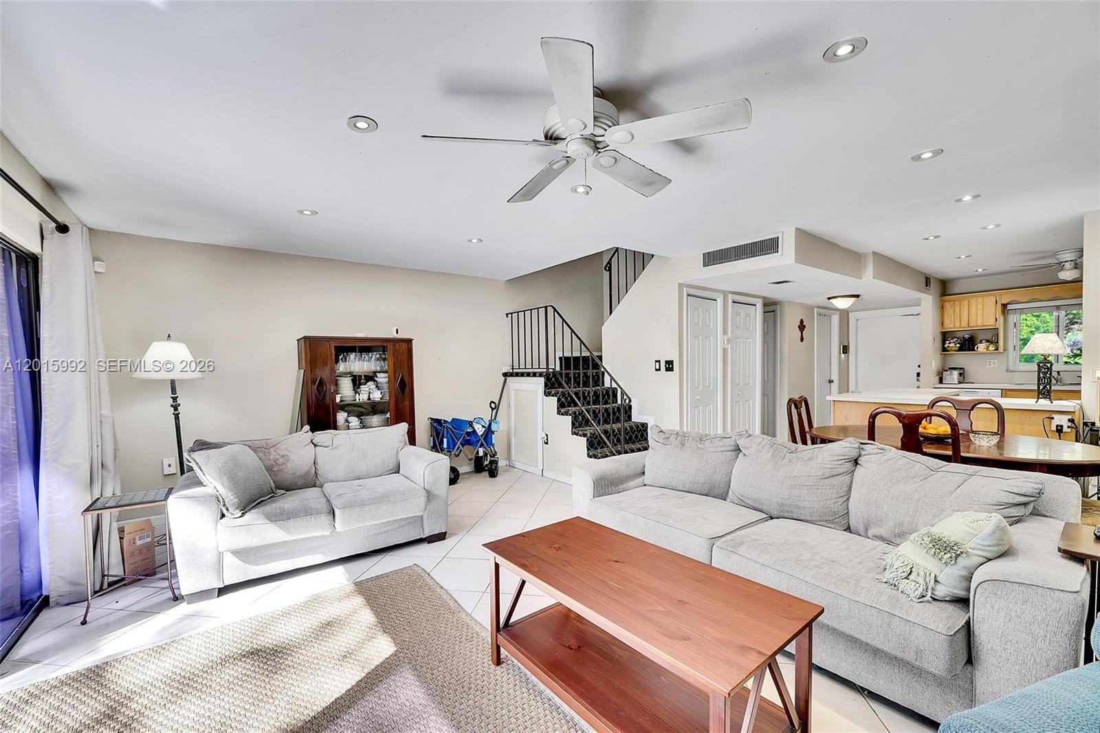 3300 Atlanta Street, Unit 15F Hollywood, FL 33021 - Photo 16 of 30 a living room with furniture and a chandelier